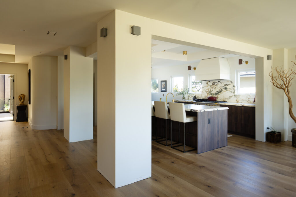 Open-concept kitchen remodel with structural wall removal and wide entry opening