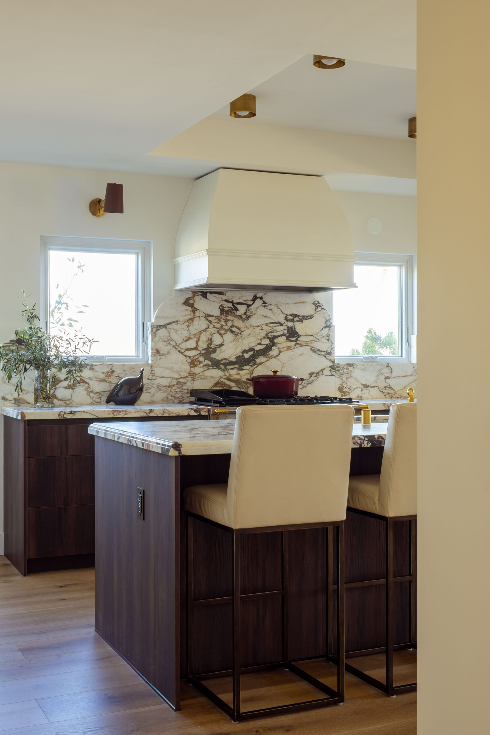 Kitchen island seating area with custom cabinetry in open-concept layout
