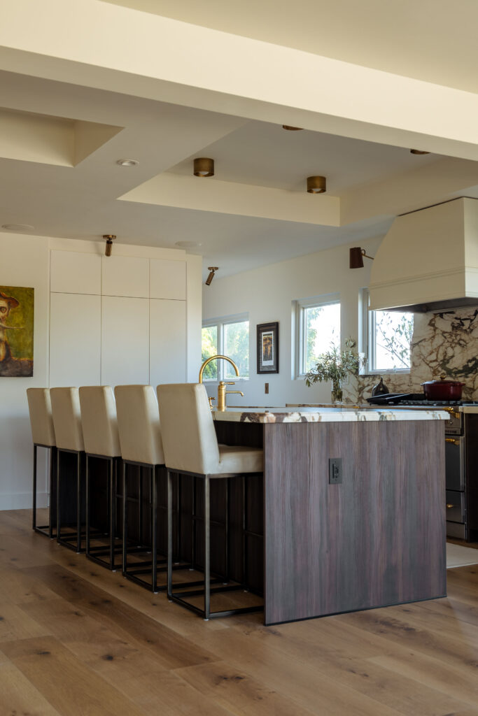 Open kitchen layout with coffered ceiling and large central island