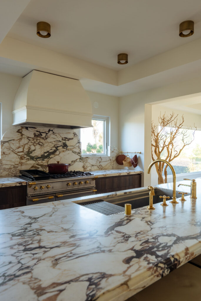 Close-up of marble countertop and backsplash with modern fixtures