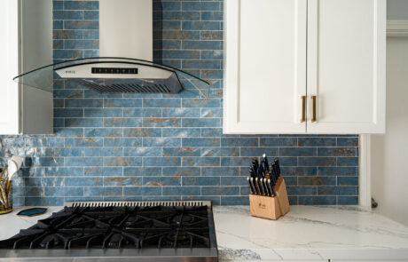 San Diego Kitchen Remodel, blue-coastal Coastal-inspired blue subway tile backsplash paired with white shaker cabinets, quartz countertops, and gold accents in Clairemont, San Diego.