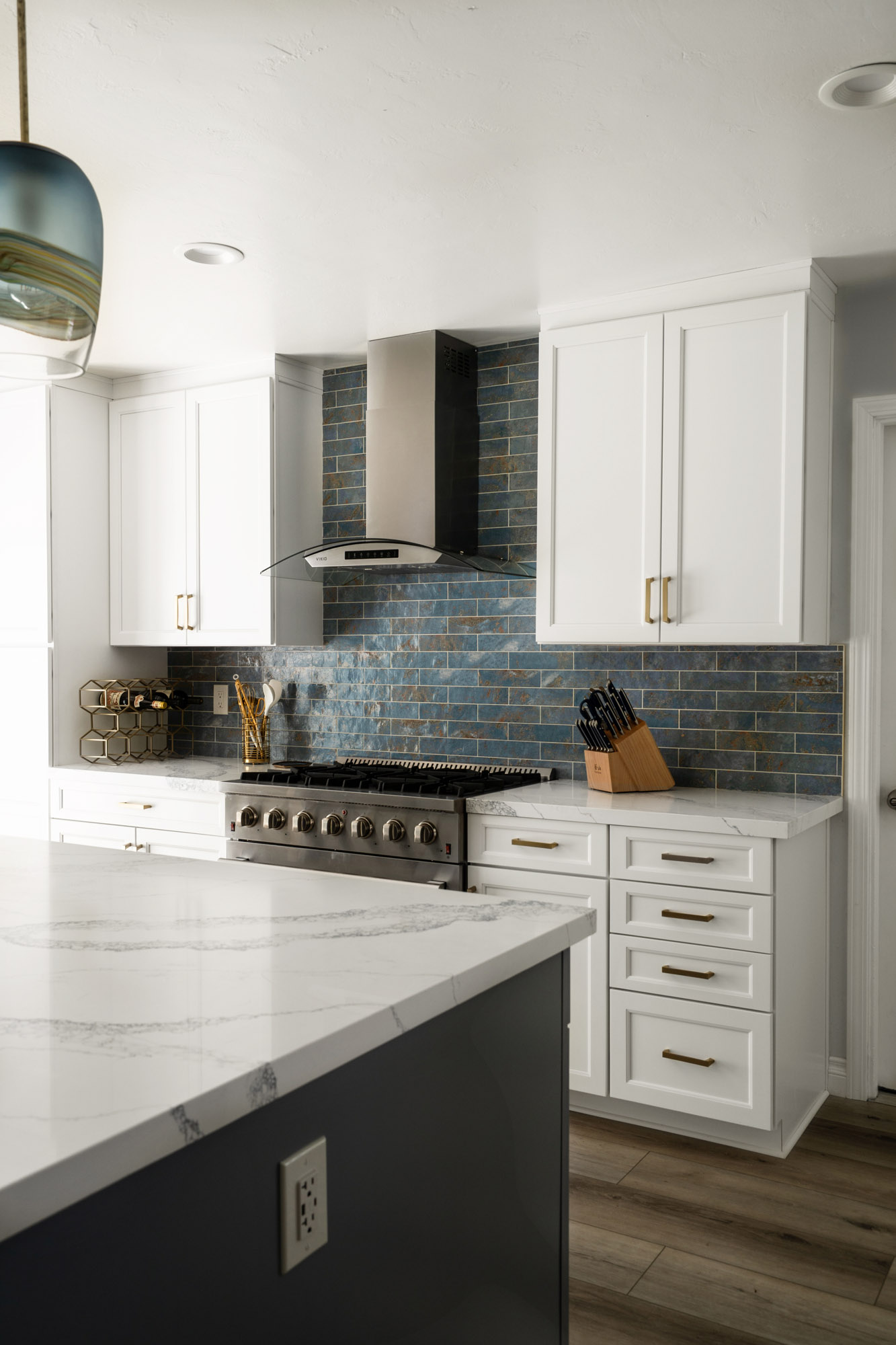San Diego Kitchen Remodel, blue-coastal Open-concept kitchen remodel in Clairemont, San Diego, with a large quartz island, white shaker cabinets, and coastal blue backsplash.
